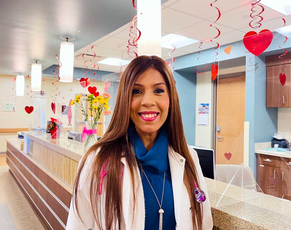 Dr. Jessica Mastrapa near reception of a Valentines Day Decorated McKenzie Health in Watford City, ND